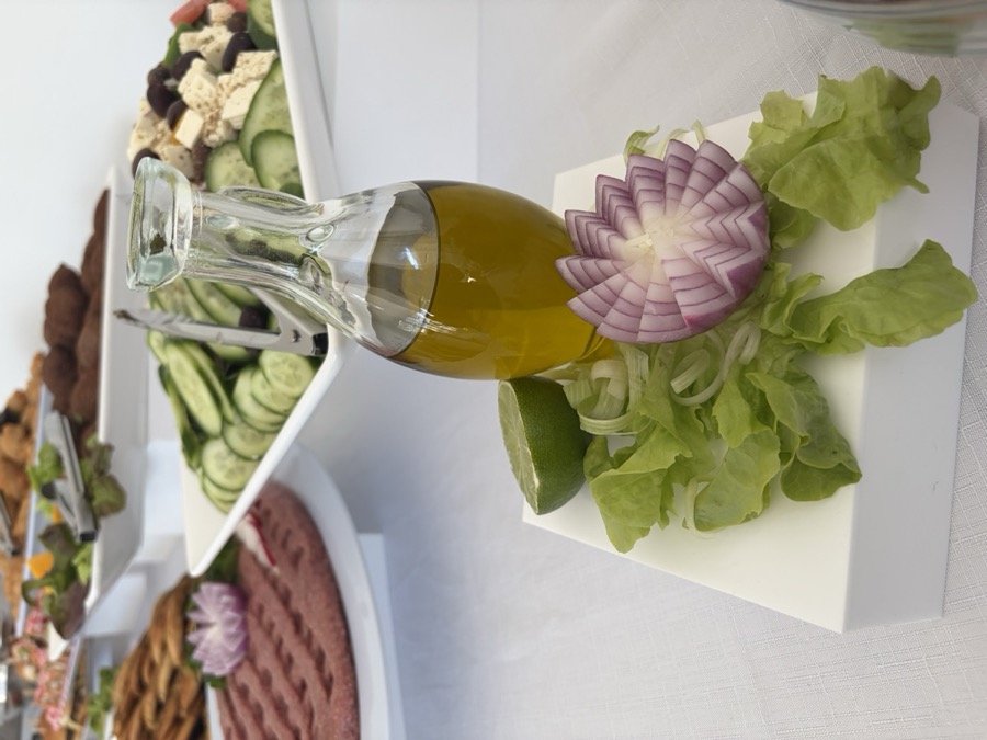 Styled table setting with olive oil and garnish